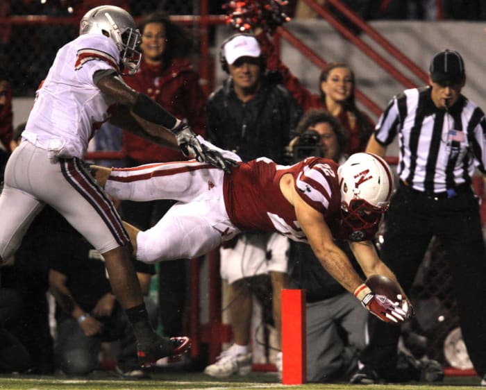 Rex Burkhead dives for the go-head touchdown on a 17-yard run. The TD came 2½ minutes after his 30-yard catch and run had tied the score.